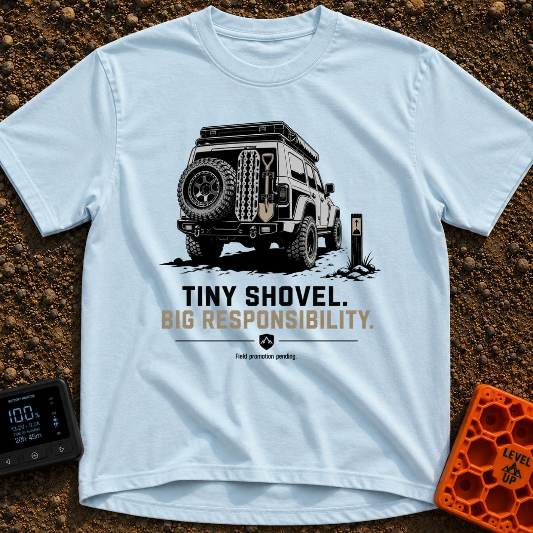 Dig Tiny Adventures - T-Shirt in Chambray - A rear-view illustration of a rugged 4x4 off-road vehicle parked near a...