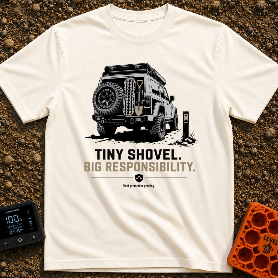 Dig Tiny Adventures - T-Shirt in Ivory - A rear-view illustration of a rugged 4x4 off-road vehicle parked near a mountain...