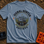 Views Over Bars - T-Shirt in Blue Jean - A circular badge illustration showing a white camper van equipped with a...
