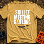 Skillet Meeting Ran Long - T-Shirt in Mustard - Text reading "SKILLET MEETING RAN LONG" above an illustration of a black...