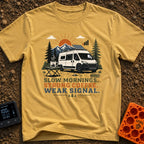 Strong Coffee Weak Signal - T-Shirt in Mustard - A white camper van with a roof-mounted solar panel is parked near pine...