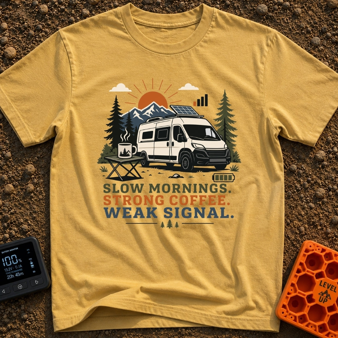 Strong Coffee Weak Signal - T-Shirt in Mustard - A white camper van with a roof-mounted solar panel is parked near pine...