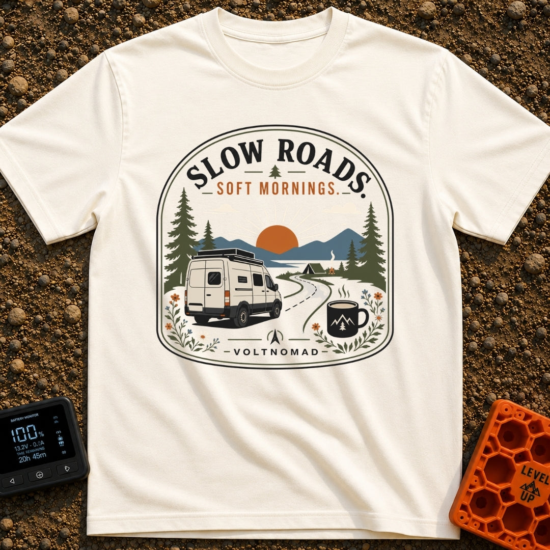 Sip Slow Roll Easy - T-Shirt in Ivory - A graphic illustration of a white camper van driving on a winding road toward a...