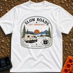 Sip Slow Roll Easy - T-Shirt in White - A graphic illustration of a white camper van driving on a winding road toward a...