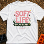 Powered By Soft Life - T-Shirt in White - A typographic design featuring large pink bubbly text reading "SOFT LIFE" above...