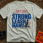 Leash The Day - T-Shirt in Bay - A typographic design featuring the text "SOFT LIGHT STRONG LEASH HAND" alongside the...