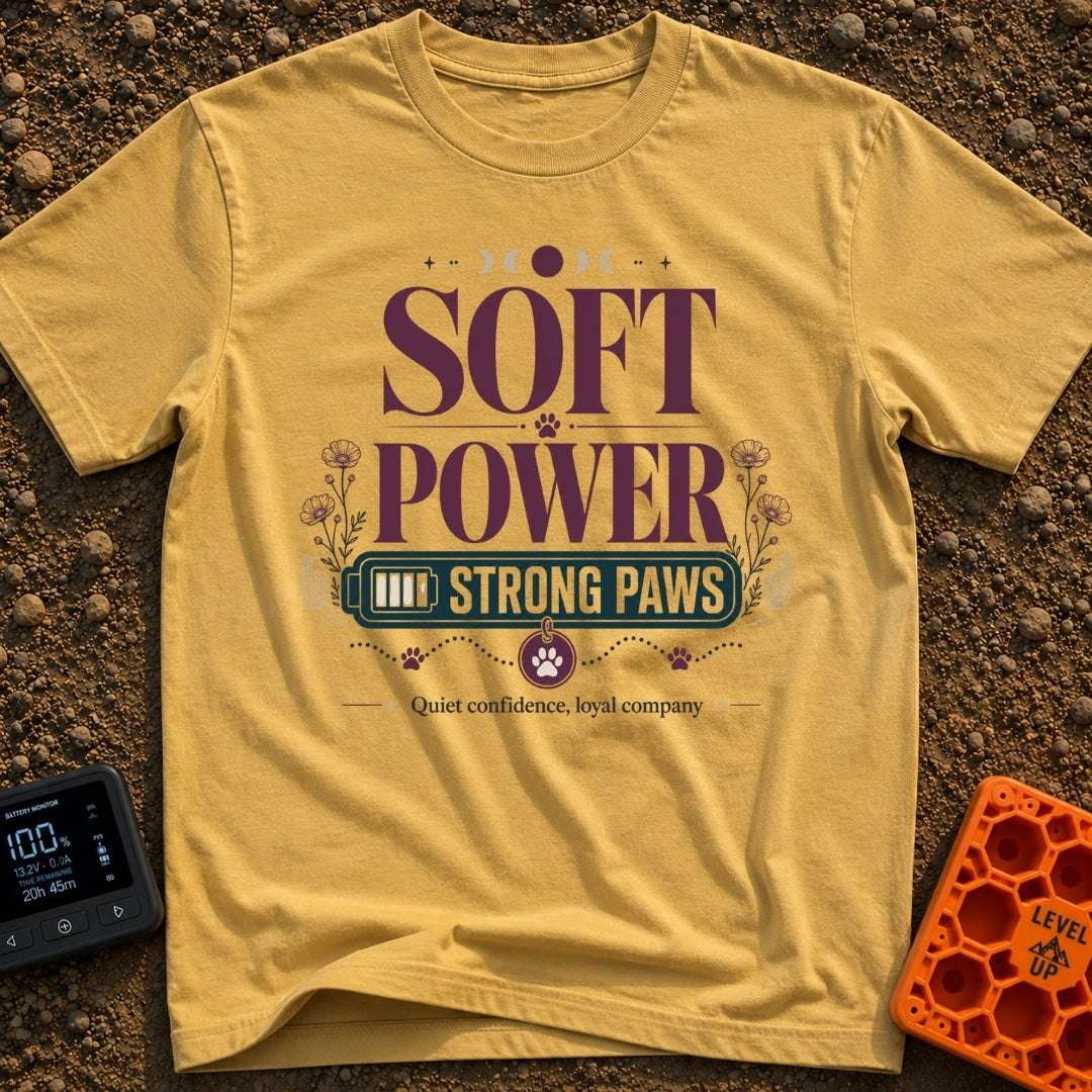 Soft Power Strong Paws - T-Shirt in Mustard - A typographic design with the words "SOFT POWER" above a banner reading...