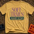 Wired For The Wild - T-Shirt in Mustard - A typographic design featuring the words "SOFT TRAILS" in large serif letters...