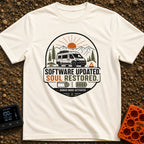 Soul Update Complete - T-Shirt in Ivory - A circular badge design featuring a white camper van parked beside a campfire,...