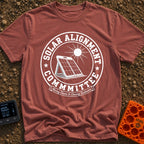 Solar Alignment Crew - T-Shirt in Brick - A distressed circular graphic featuring a portable folding solar panel propped...