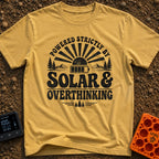 Solar Powered Overthinking - T-Shirt in Mustard - A distressed, black-and-white typographic design reading 'POWERED...