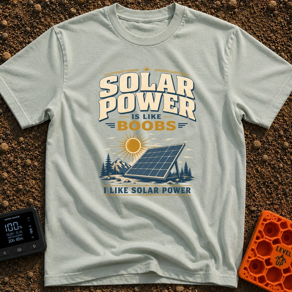 Solar Is Like Boobs - T-Shirt in Bay - A large, freestanding solar panel sits on the ground in a natural landscape...