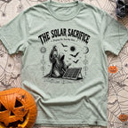 Praise The Solar Gods - T-Shirt in Bay - A black and white illustration of a cloaked, hooded figure kneeling in a ritual...