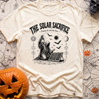 Praise The Solar Gods - T-Shirt in Ivory - A black and white illustration of a cloaked, hooded figure kneeling in a...