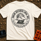 Solar Watchers Union - T-Shirt in Ivory - A black-and-white circular badge design featuring a stylized sun with a face...