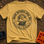 Solar Watchers Union - T-Shirt in Mustard - A black-and-white circular badge design featuring a stylized sun with a face...
