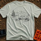 Latest Stable Release - T-Shirt in Bay - A black and white line drawing of a camper van parked beside a lake, with an...