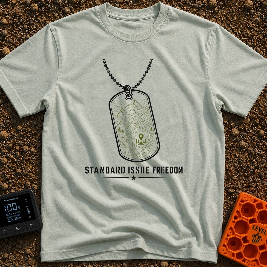 Standard Issue Freedom - T-Shirt in Bay - A line-art illustration of a military dog tag hanging from a beaded chain,...