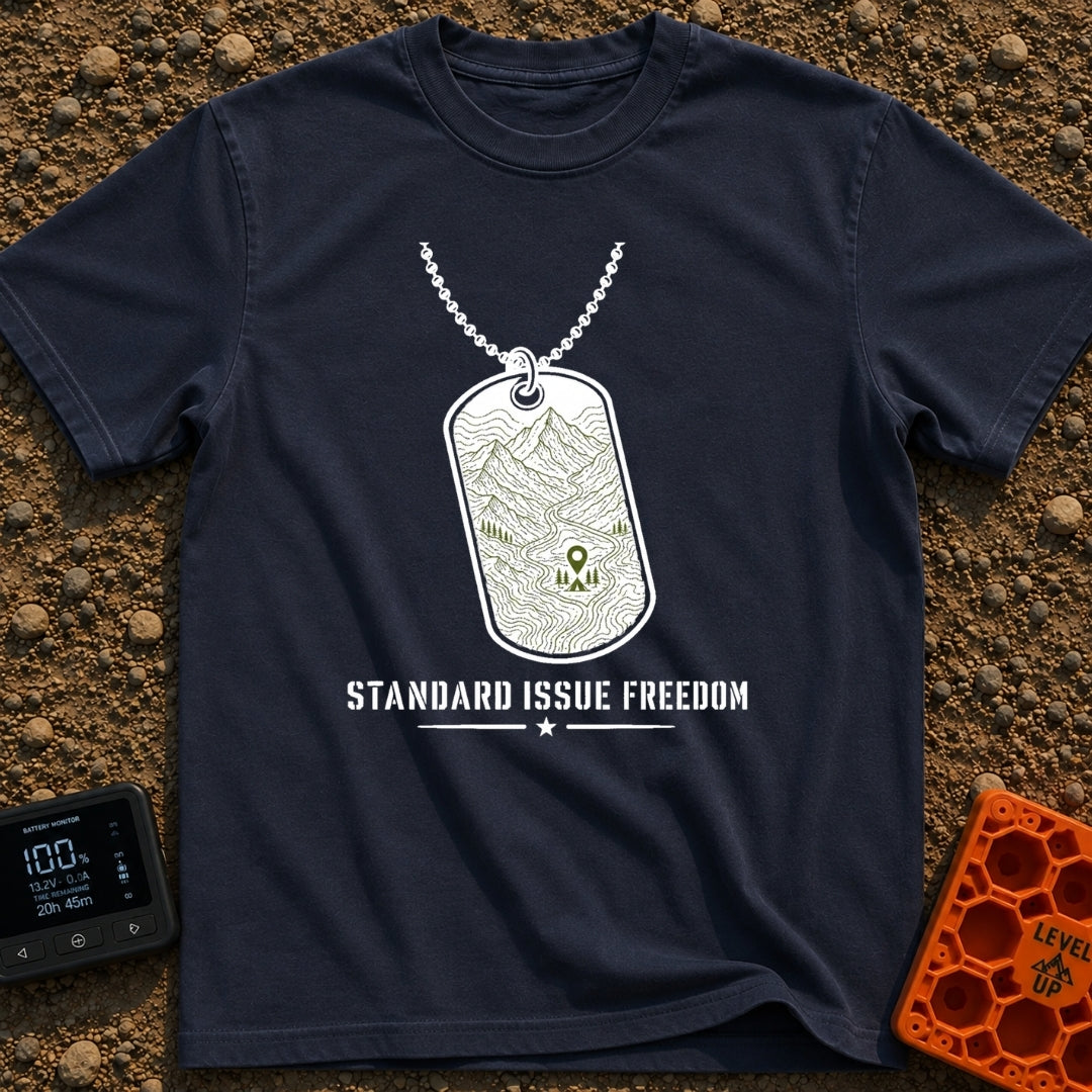 Standard Issue Freedom - T-Shirt in Navy - A line-art illustration of a military dog tag hanging from a beaded chain,...