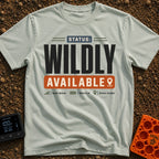 Wildly Available Status - T-Shirt in Bay - A typographic design featuring the text "STATUS: WILDLY AVAILABLE" stacked...