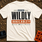 Wildly Available Status - T-Shirt in Ivory - A typographic design featuring the text "STATUS: WILDLY AVAILABLE" stacked...