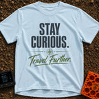 Curiosity Travels Further - T-Shirt in Chambray - A typographic design featuring the words "STAY CURIOUS." in large, dark...