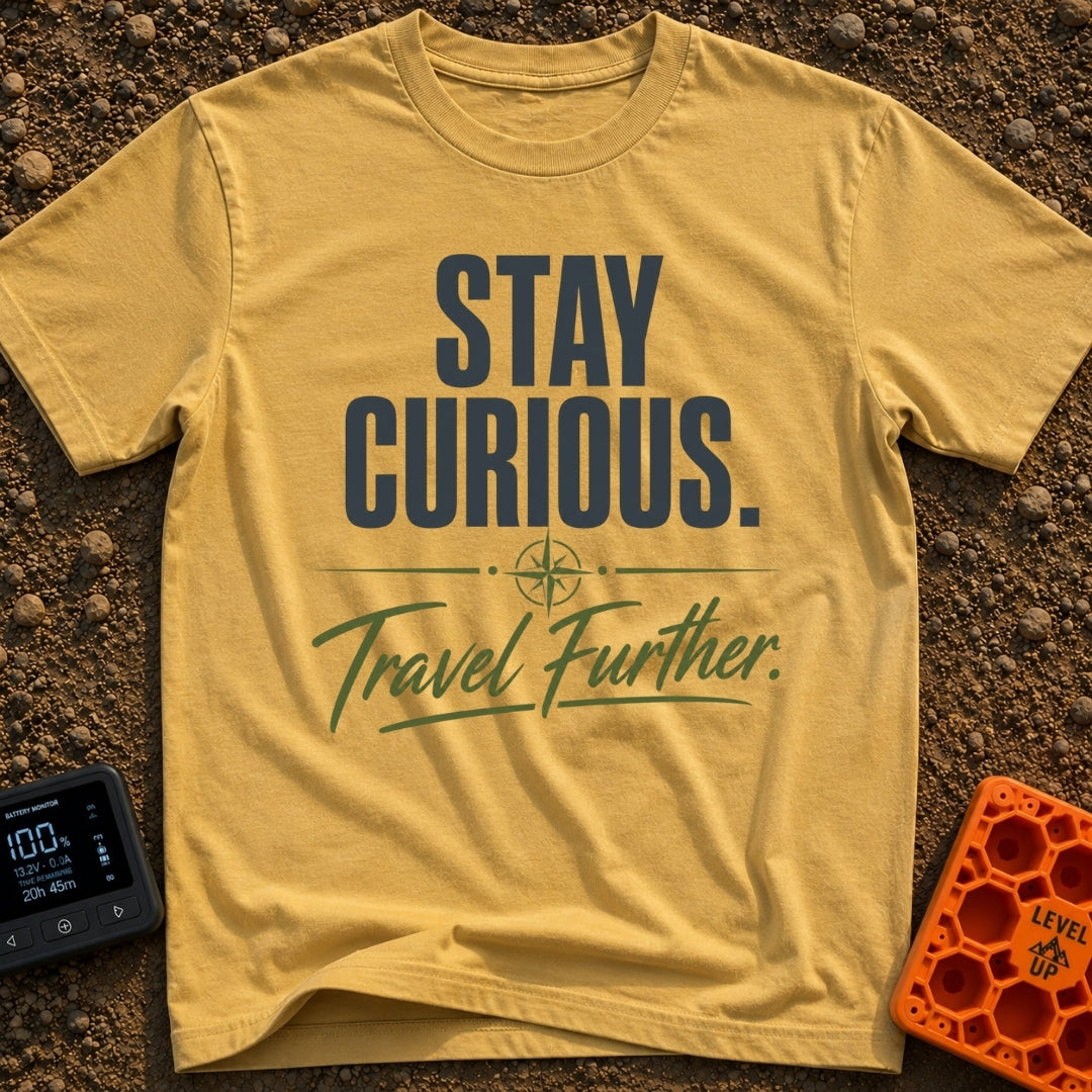 Curiosity Travels Further - T-Shirt in Mustard - A typographic design featuring the words "STAY CURIOUS." in large, dark...