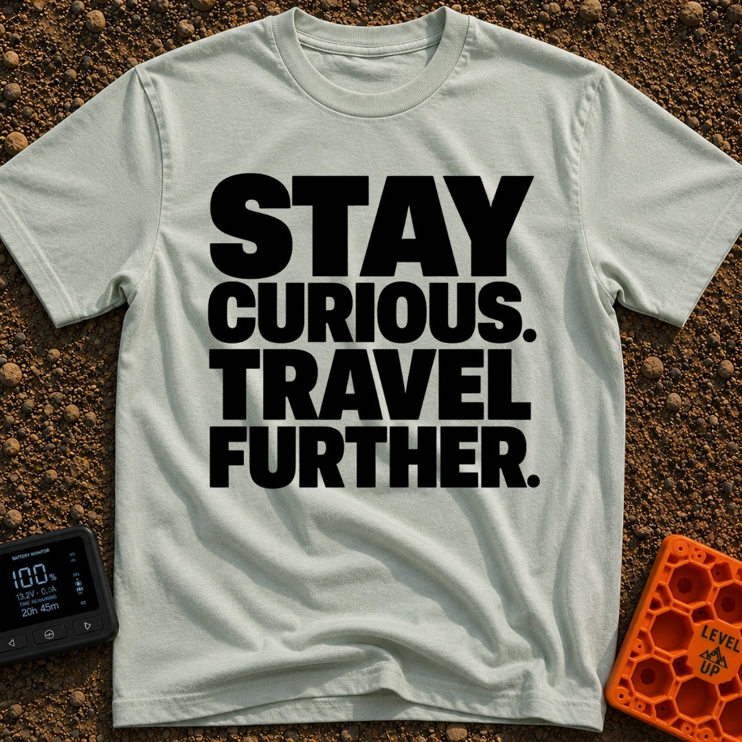 Driven By Curiosity - T-Shirt in Bay - A text-only design featuring the phrase "STAY CURIOUS. TRAVEL FURTHER." stacked in...