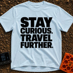 Driven By Curiosity - T-Shirt in Chambray - A text-only design featuring the phrase "STAY CURIOUS. TRAVEL FURTHER."...