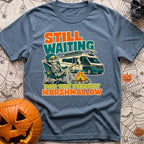 Chasing The Perfect Roast - T-Shirt in Blue Jean - A skeleton wearing a beanie and sunglasses sits in a camp chair beside...
