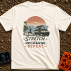 Stretch Recharge Repeat - T-Shirt in Ivory - A silhouette of a woman doing a yoga pose on a beach next to an open camper...