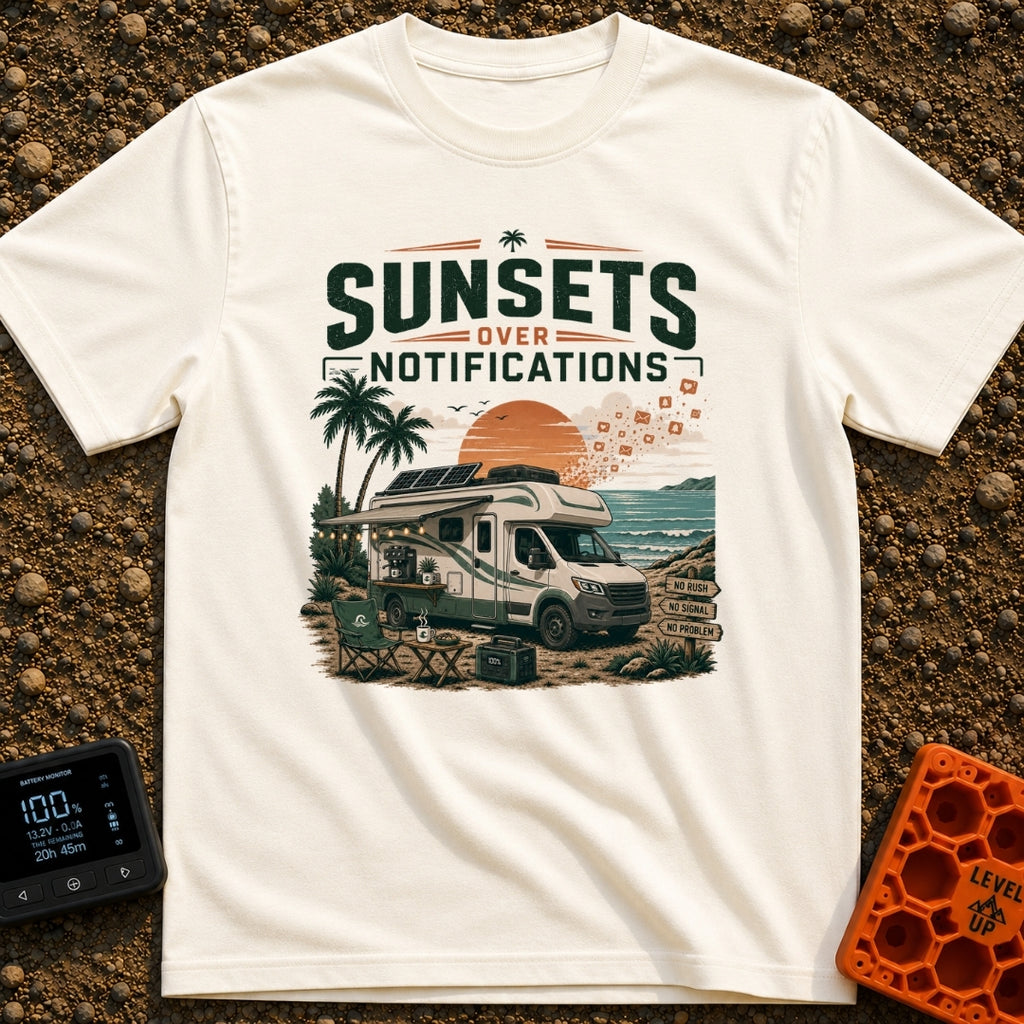 Sunsets Over Screens - T-Shirt in Ivory - An RV parked on a beach at sunset with solar panels on the roof, an awning...