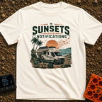 Sunsets Over Screens - T-Shirt in Ivory - An RV parked on a beach at sunset with solar panels on the roof, an awning...