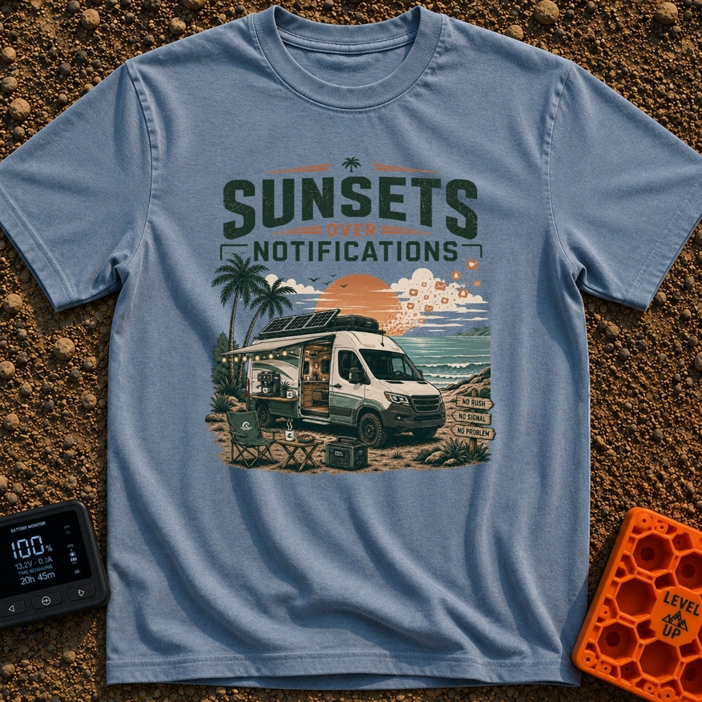 Sunsets Over Screens - T-Shirt in Blue Jean - A camper van is parked on a beach at sunset with its side door open,...
