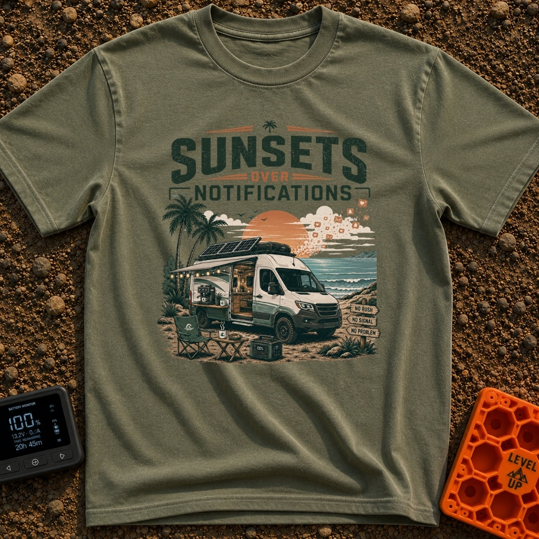 Sunsets Over Screens - T-Shirt in Moss - A camper van is parked on a beach at sunset with its side door open, revealing a...