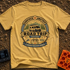 Relationship Milestone Unlocked - T-Shirt in Mustard - A badge-style design featuring a white camper van parked in front...