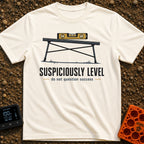 Seems Suspiciously Level - T-Shirt in Ivory - A yellow spirit level resting horizontally on top of a black folding camp...