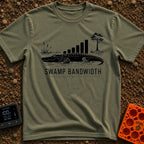 Buffering In The Bayou - T-Shirt in Moss - A black and white illustration of an alligator in water with swamp vegetation,...