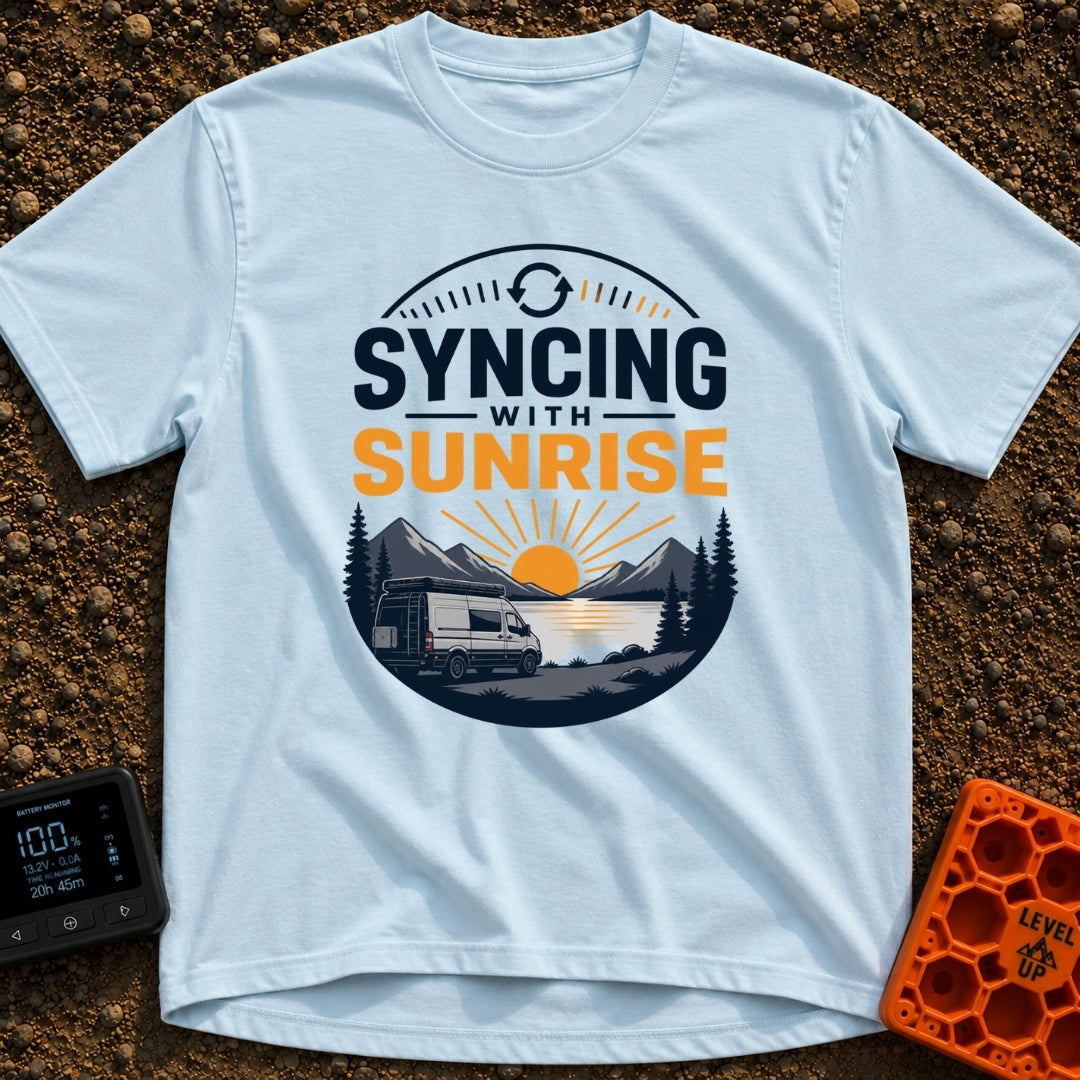 Rise And Sync - T-Shirt in Chambray - A circular badge design featuring a white camper van parked by a lake with...