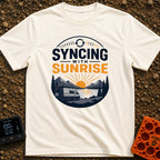 Rise And Sync - T-Shirt in Ivory - A circular badge design featuring a white camper van parked by a lake with mountains...