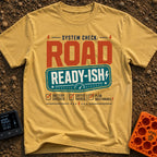 Road Ready Ish - T-Shirt in Mustard - A typographic design with the text "SYSTEM CHECK: ROAD READY-ISH" above three...