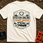 Camp Mode Activated - T-Shirt in Ivory - A badge-style illustration showing a camper van parked near a campfire and an...