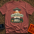 Take Me To Camp - T-Shirt in Brick - An illustration of a classic white motorhome parked at a campsite at night, with a...