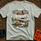 The Coffee Never Lies - T-Shirt in Bay - An illustration of a camper van parked on leveling blocks in a mountain...