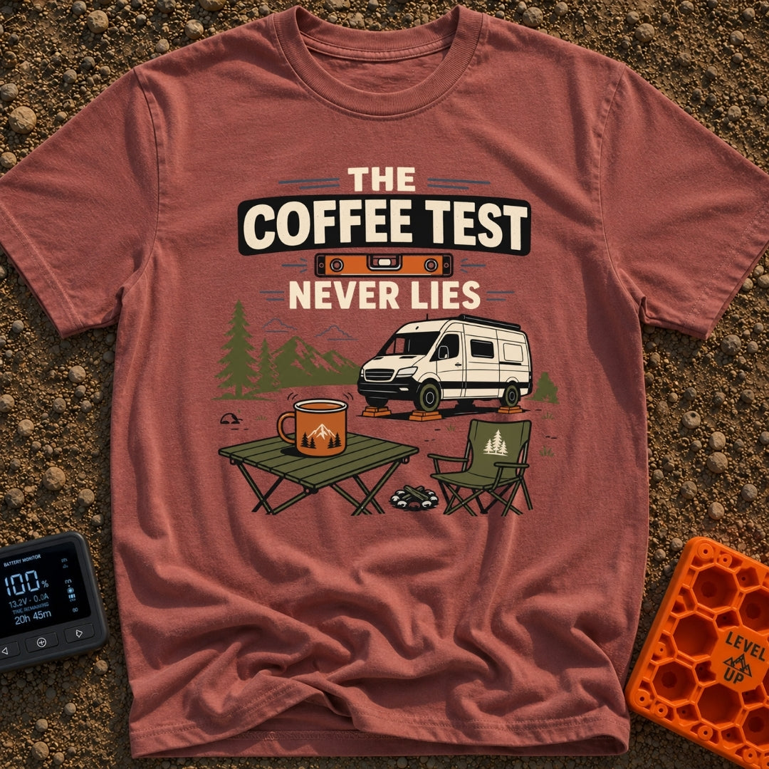 The Coffee Never Lies - T-Shirt in Brick - An illustration of a camper van parked on leveling blocks in a mountain...