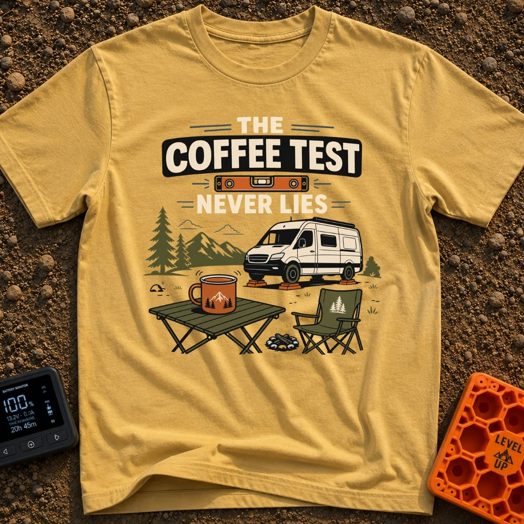 The Coffee Never Lies - T-Shirt in Mustard - An illustration of a camper van parked on leveling blocks in a mountain...