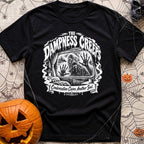 The Damp Creeps In - T-Shirt in Black - A black-and-white illustration of a swamp creature with webbed hands pressing...