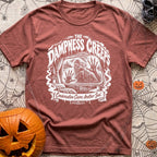 The Damp Creeps In - T-Shirt in Brick - A black-and-white illustration of a swamp creature with webbed hands pressing...
