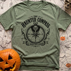Dead Reckoning Society - T-Shirt in Moss - A black and white illustration of an ornate, vintage-style compass with a...