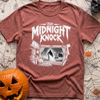 Fear The Knock - T-Shirt in Brick - A black and white illustration looking from the inside of a camper out the window,...